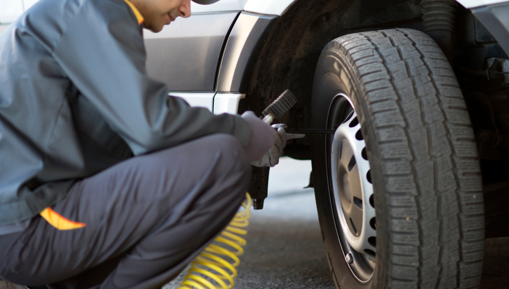 Mechanic checking tyre pressure